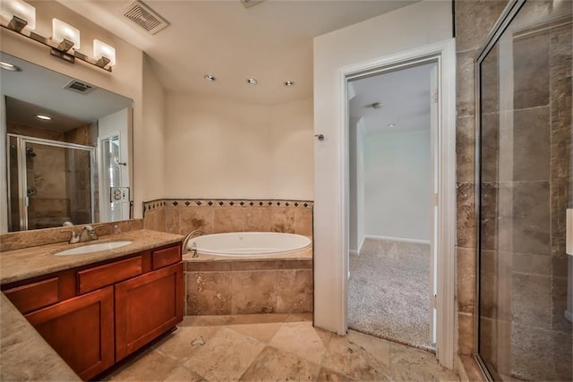 bathroom with independent shower and bath and vanity