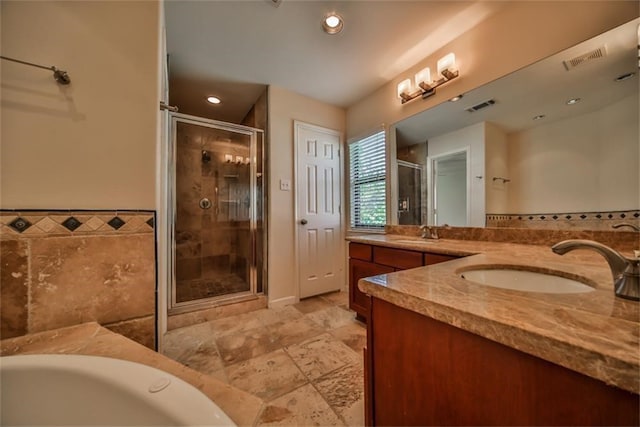 bathroom with vanity and separate shower and tub