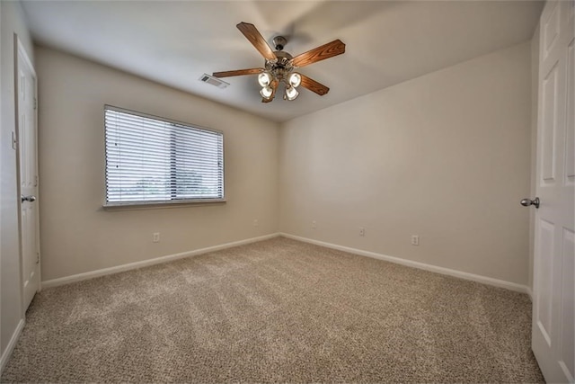 spare room featuring carpet flooring and ceiling fan