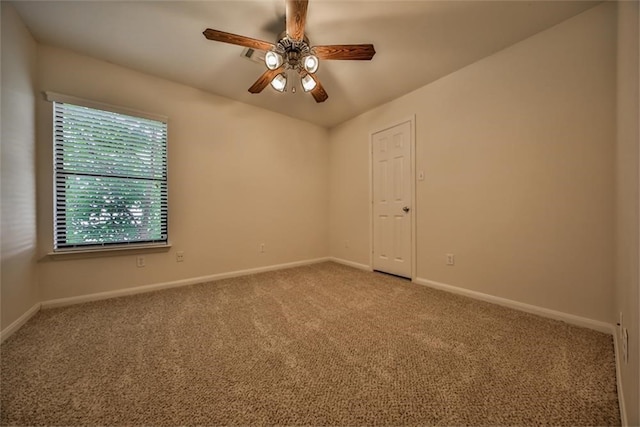 carpeted spare room featuring ceiling fan