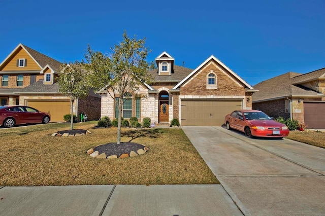 view of front of property featuring a garage and a front yard