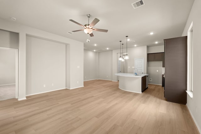 interior space featuring light hardwood / wood-style flooring, ceiling fan, and sink