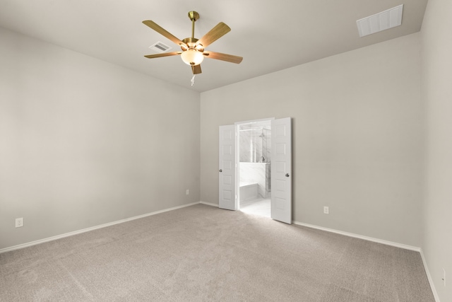 unfurnished bedroom featuring ensuite bathroom, ceiling fan, and light colored carpet