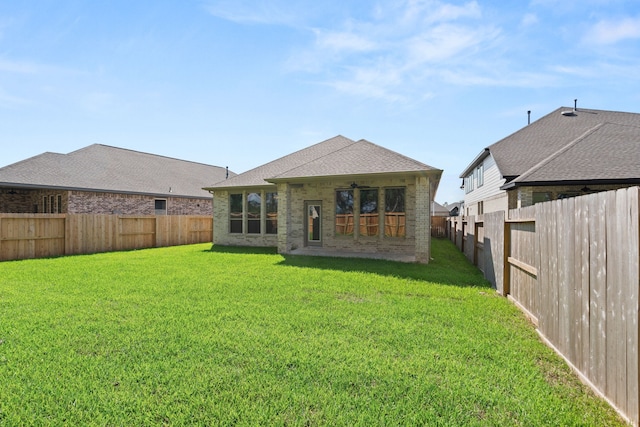 back of property featuring a lawn