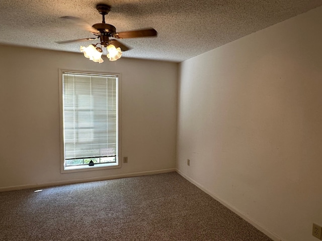 carpeted empty room featuring a textured ceiling and ceiling fan