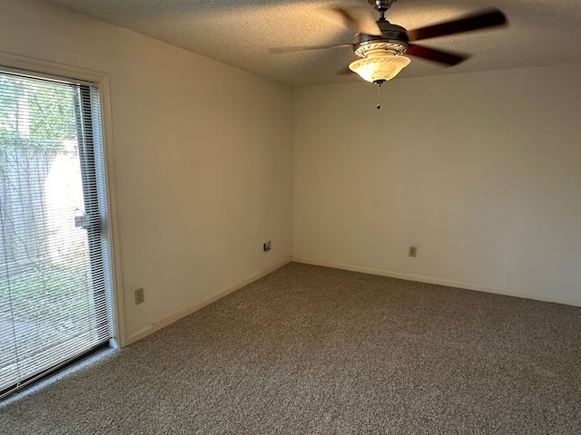 unfurnished room with ceiling fan, a textured ceiling, and carpet flooring