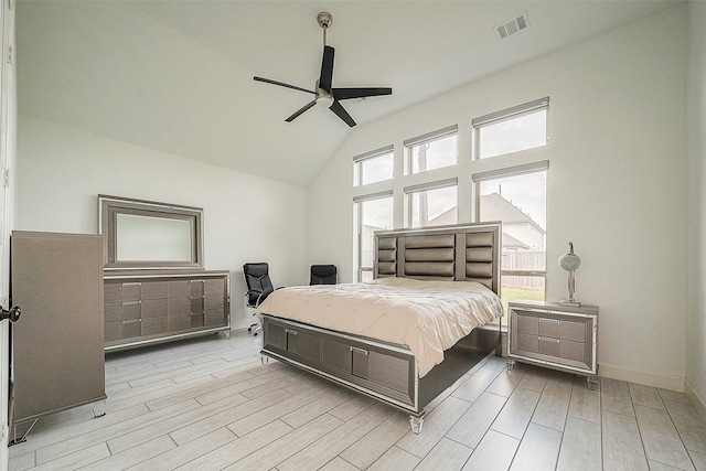 bedroom featuring light wood-type flooring, ceiling fan, and high vaulted ceiling