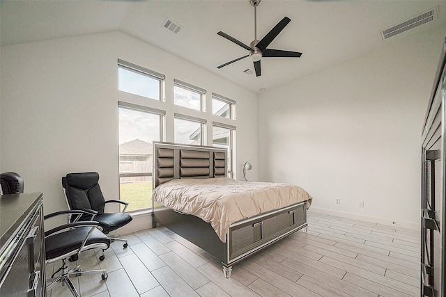 bedroom featuring high vaulted ceiling, light hardwood / wood-style floors, and ceiling fan