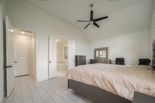 bedroom with ceiling fan, connected bathroom, light wood-type flooring, and lofted ceiling