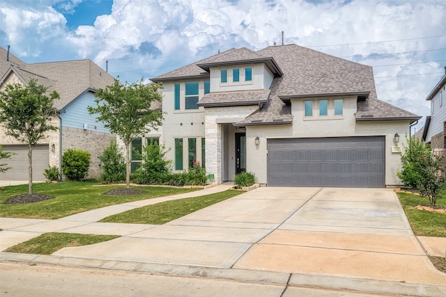 view of front of house featuring a garage and a front yard