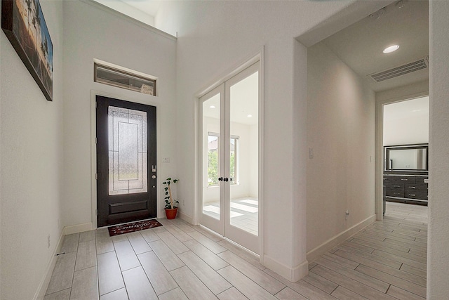 entryway featuring light hardwood / wood-style floors and french doors