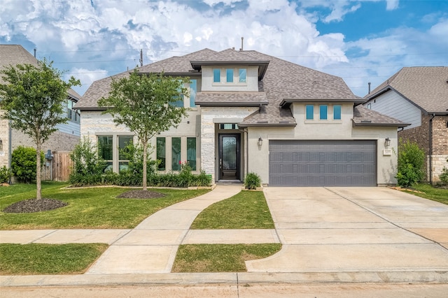 view of front facade with a garage and a front lawn