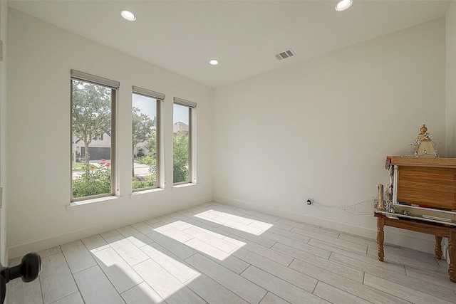 unfurnished room with light hardwood / wood-style floors