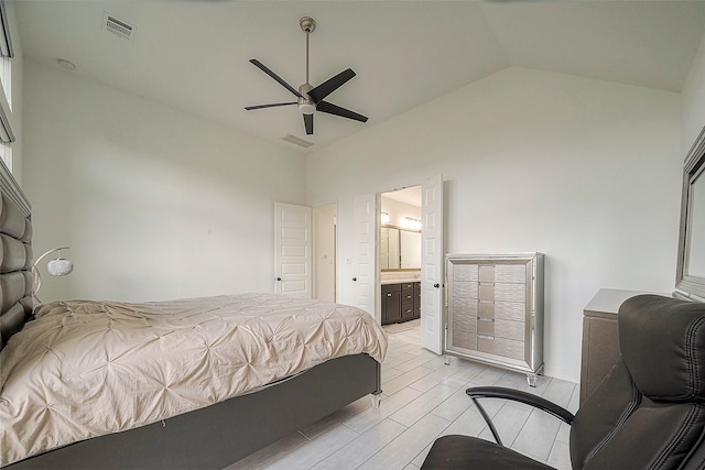 bedroom featuring light wood-type flooring, vaulted ceiling, ceiling fan, and ensuite bathroom