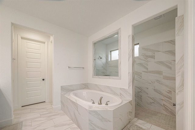 bathroom featuring shower with separate bathtub