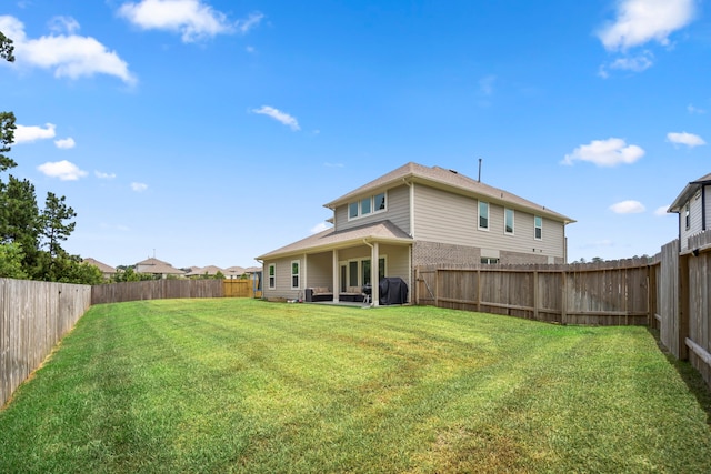 rear view of property with a yard