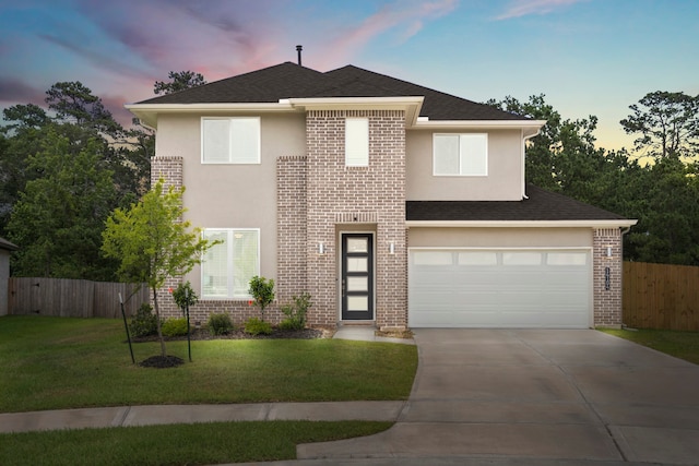 view of front of property with a lawn and a garage