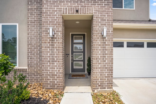 doorway to property with a garage