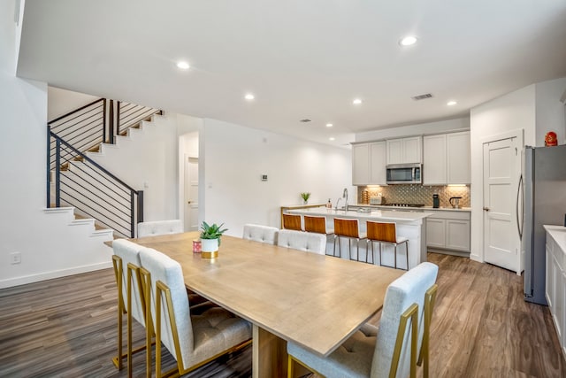 dining room with dark hardwood / wood-style floors and sink