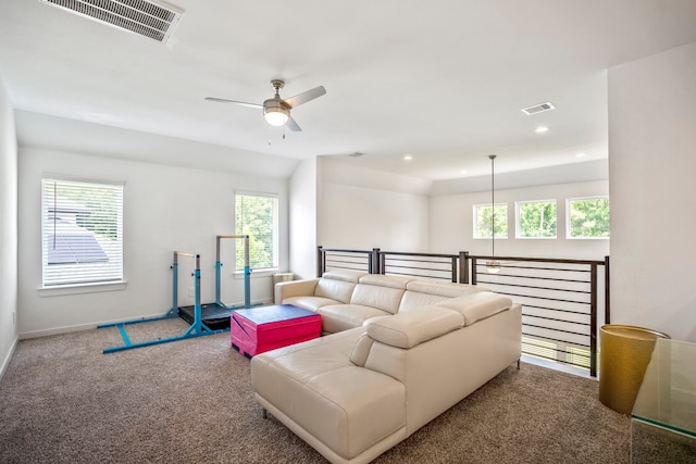 living room with ceiling fan, carpet flooring, and a healthy amount of sunlight