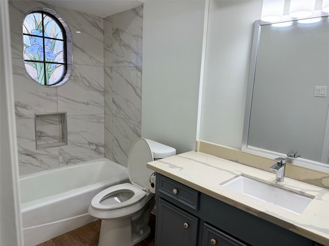 full bathroom featuring vanity, toilet, and tiled shower / bath