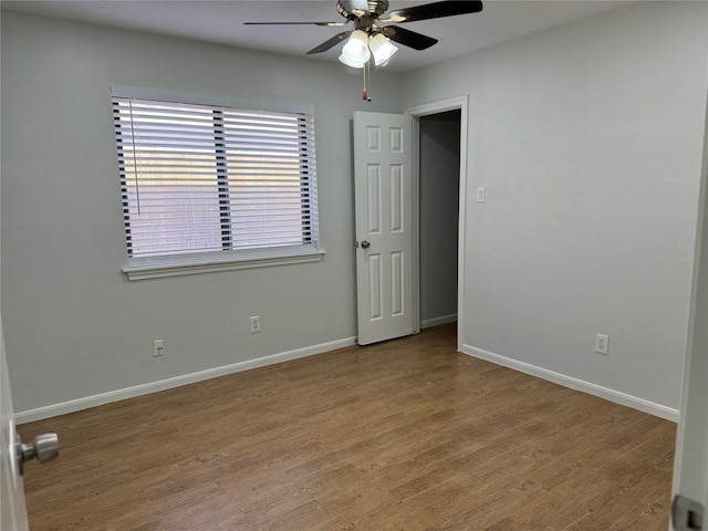 empty room featuring light hardwood / wood-style flooring and ceiling fan