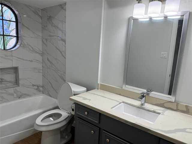 full bathroom featuring vanity, toilet, and tiled shower / bath combo