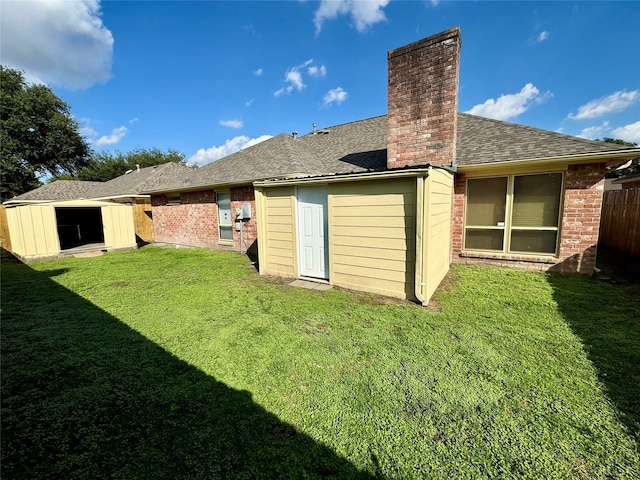 rear view of property with a storage shed and a lawn