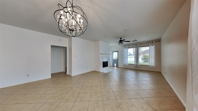 unfurnished living room featuring ceiling fan with notable chandelier and light tile patterned floors