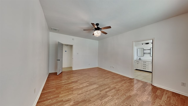 unfurnished room with ceiling fan and light wood-type flooring