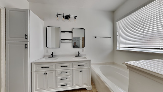 bathroom with a tub to relax in and vanity