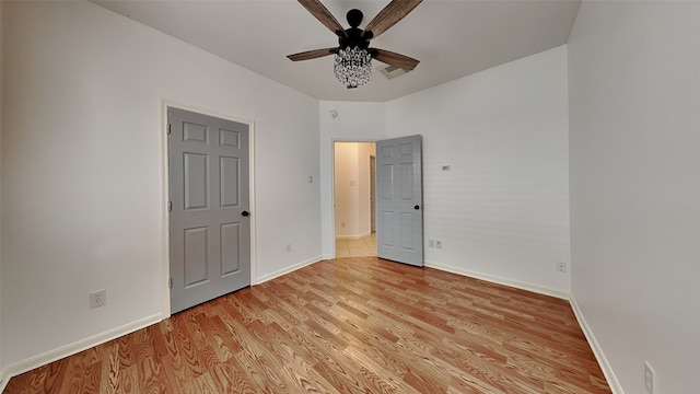 unfurnished bedroom with ceiling fan and light hardwood / wood-style floors