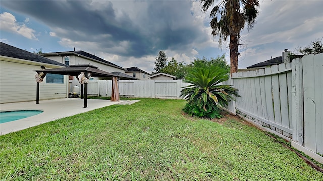 view of yard with a fenced in pool, a patio, and a gazebo