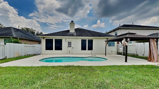 back of house with a fenced in pool, a yard, a gazebo, and a patio area