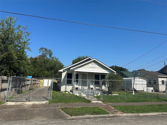 bungalow-style home featuring a porch and a front yard