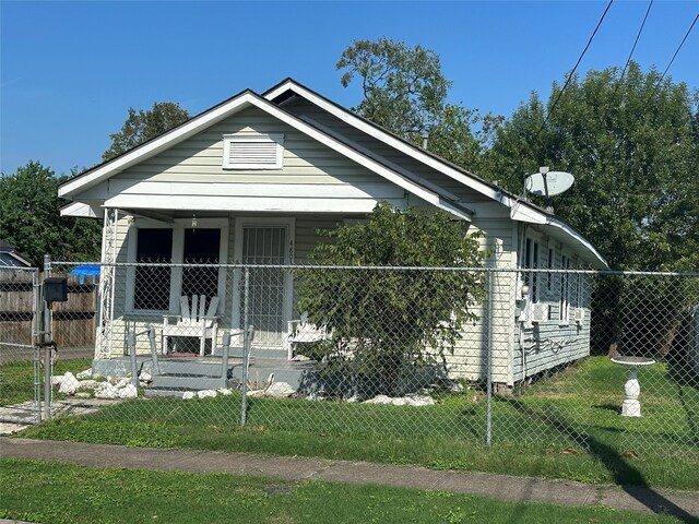 bungalow featuring a porch and a front yard