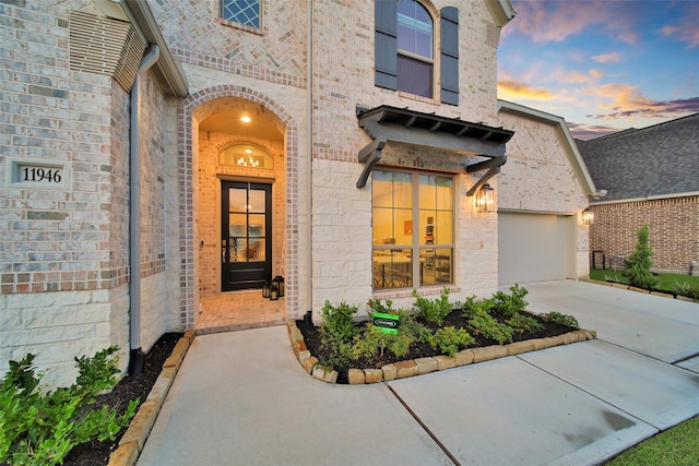 exterior entry at dusk with a garage