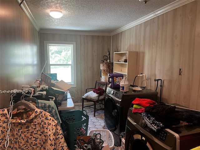 bedroom with a textured ceiling, washer / clothes dryer, and ornamental molding