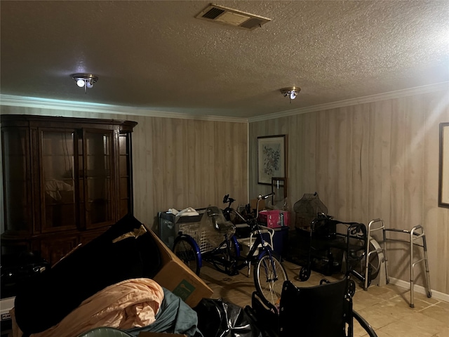 interior space featuring ornamental molding, a textured ceiling, and light tile patterned flooring