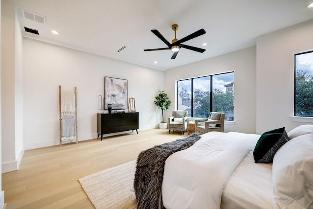 bedroom with ceiling fan and light hardwood / wood-style flooring