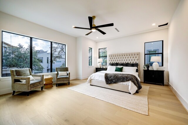 bedroom with ceiling fan and light hardwood / wood-style floors