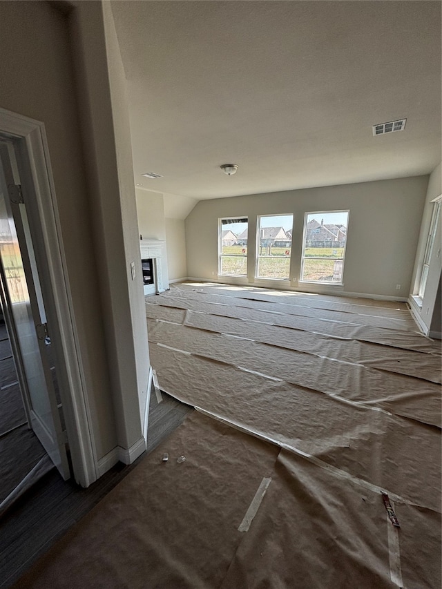 unfurnished bedroom featuring lofted ceiling