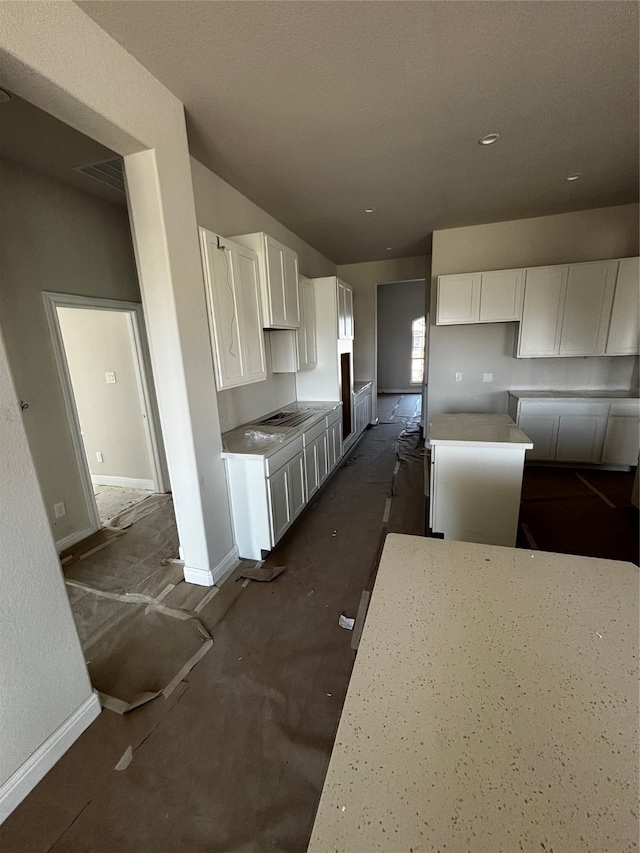 kitchen with white cabinets and a center island