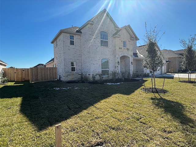 french provincial home with a garage and a front yard