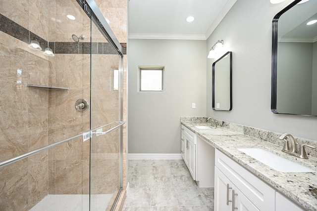 bathroom with a shower with shower door, vanity, and crown molding