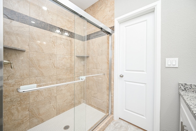 bathroom featuring a shower with shower door