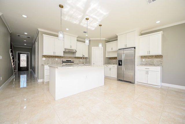 kitchen featuring white cabinets, stainless steel appliances, hanging light fixtures, and an island with sink