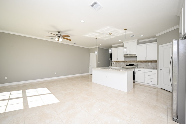 kitchen with white cabinetry, a center island with sink, appliances with stainless steel finishes, hanging light fixtures, and decorative backsplash