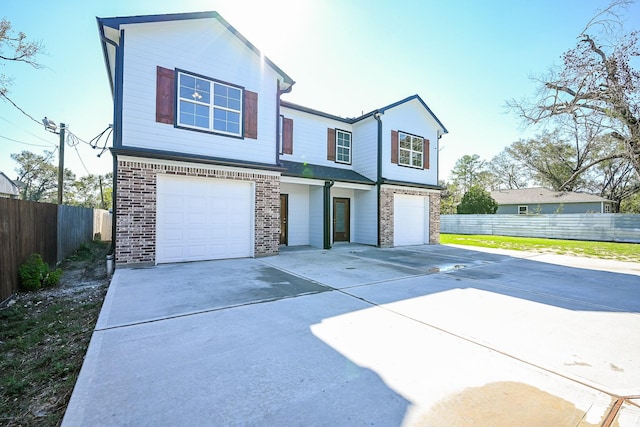 6122 Hopper Rd, Houston, TX 77016 - view of front of house featuring a garage, concrete driveway, fence, and brick siding
