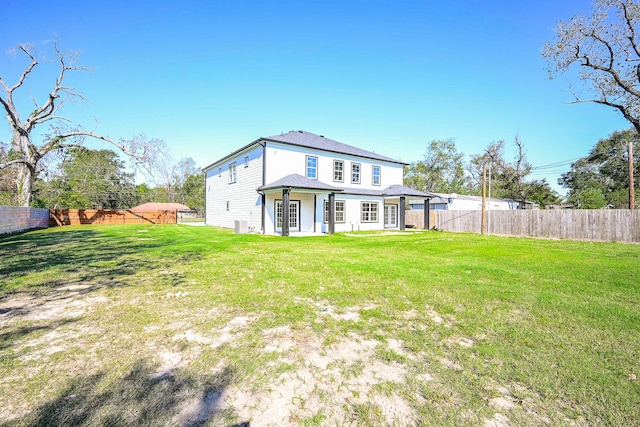 back of house with a lawn